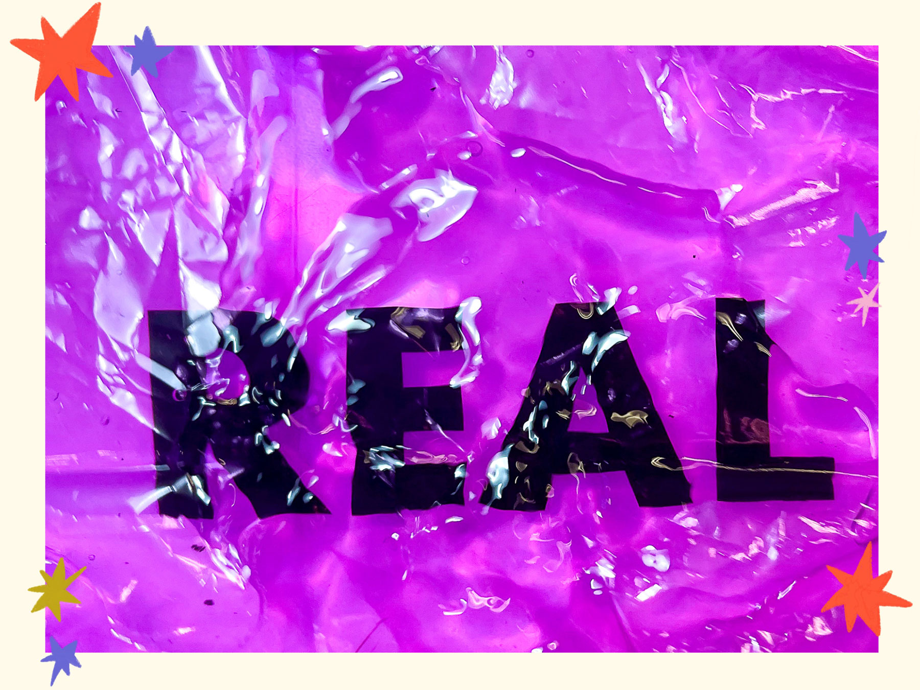 the text 'real' floating in a bath of water above pink cellophane.
