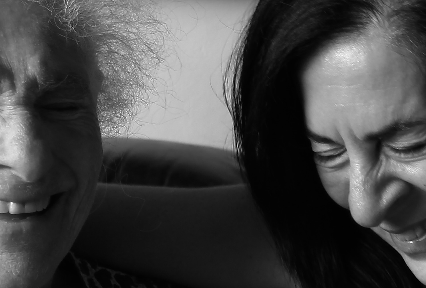 A Mother and Daughter laughing, zoomed in on only their faces